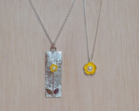 two silver pendant with gold flowers and pearls
