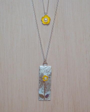 two pendants with gold flowers with pearls in the middle